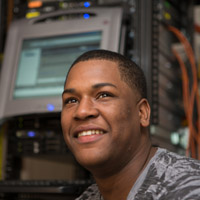 student in front of server rack