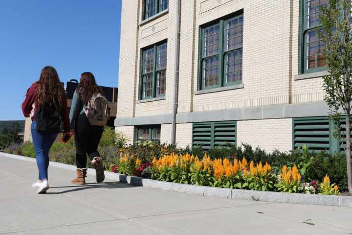 Students walking in front of Frisbie Hall